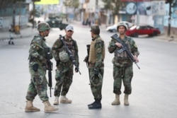 Afghan soldiers stand guard near a polling station in Kabul, Afghanistan, Sept. 28, 2019.