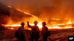 Fire crews battle the Kenneth Fire in the West Hills section of Los Angeles, California, Jan. 9, 2025.