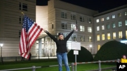 Marianne Hoenow from the U.S. state of Connecticut celebrates the victory of President-elect Joe Biden and Vice President-elect Kamala Harris in front of the U.S. Embassy next to the Brandenburg Gate in Berlin, Germany, Nov. 7, 2020. 