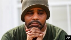 Jamon Jordan sits outside of his home in Detroit, April 24, 2020. Jordan could not mourn his mother, Jacquelynne Jordan, in the traditional way.