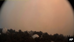 This photo provided by High Performance Wireless Research and Education Network and ALERTWildfire from a camera atop Mount Wilson shows dense smoke shrouding the famed Southern California observatory, Sept. 16, 2020.