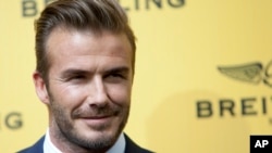 FILE - English former footballer David Beckham poses for photographers.