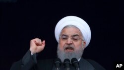 FILE - Iranian President Hassan Rouhani speaks during a ceremony celebrating the 40th anniversary of the Islamic Revolution, at the Azadi, Freedom, Square in Tehran, Feb. 11, 2019.