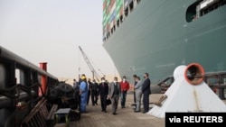 Oussama Rabieh, chairman of the Suez Canal Authority, monitors the situation near the stranded container ship Ever Given after it ran aground, in Suez Canal, Egypt, March 25, 2021. 