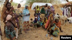 Nigerian refugees, who fled from their village into Niger following Boko Haram attacks, stand in the yard of their Nigerien host in Diffa in southeastern Niger, June 21, 2016. 
