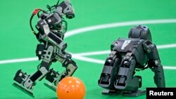 Robots play soccer in the Kids League at the RoboCup German Open 2014 in Magdeburg, Germany, April 3, 2014. (Reuters)