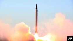 This picture released by the official website of the Iranian Defense Ministry on Sunday, Oct. 11, 2015, claims to show the launching of an Emad long-range ballistic surface-to-surface missile in an undisclosed location. Iran successfully test fired a new 