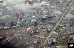 FILE - Destroyed houses are seen in this aerial view of the town of Meulaboh in Aceh province, Indonesia, which was flattened by tidal waves, Jan. 1, 2005.