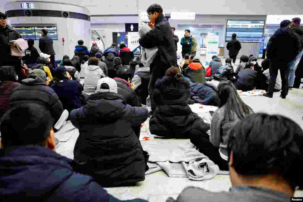 Relatives of passengers of the aircraft that crashed after it went off the runway, gather at Muan International Airport, Dec. 29, 2024.