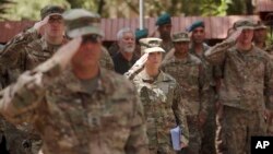 FILE - U.S. soldiers salute at Resolute Support headquarters in Kabul, Afghanistan, July 15, 2017.