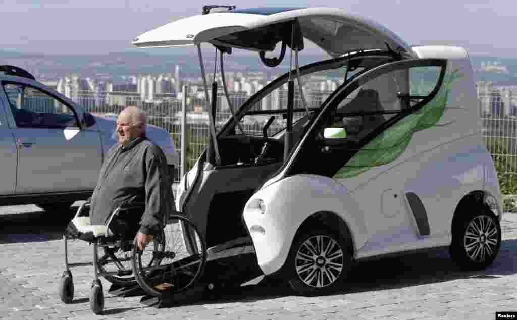 Frantisek Trunda, 67, moves himself into his Elbee vehicle while seated on a wheelchair in Brno, Czech Republic. The Elbee is a vehicle designed specifically for wheelchair-bound people, and allows them to drive the vehicle without needing to get off their wheelchair or receive assistance from another person.