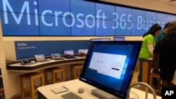 FILE - In this Jan. 28, 2020 file photo a Microsoft computer is among items displayed at a Microsoft store in suburban Boston.