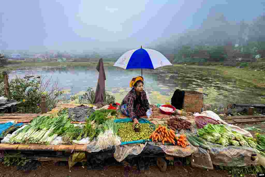 A vendor prepares her stall as she waits for customer at a street market in Taunggyi, Myanmar&#39;s northeast Shan Sate.
