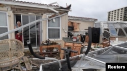  Homeowner Joe Lovece surveys the damage to the kitchen at the back of his oceanfront home after the eye of Hurricane Matthew passed Ormond Beach, Florida, on October 7, 2016. Lovece rode out the storm as waves took away the room at the back of his home. 