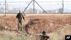 FILE - Israeli soldiers search for two Palestinians who broke out of prison, near Gan Ner, Israel, Sept. 12, 2021. The last two of six escapees were rearrested Sept. 19, the Israeli military said.