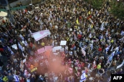 As they protest in front of the Israeli Defense Ministry in Tel Aviv, Israel, demonstrators call for the release of Israeli hostages held captive since the October 7 attacks by Palestinian militants in the Gaza Strip, Nov. 2, 2024.