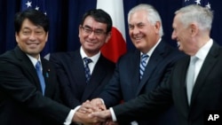 From left, Japanese Defense Minister Itsunori Onodera, Japanese Foreign Minister Taro Kono, Secretary of State Rex Tillerson and Defense Secretary James Mattis shake hands "ASEAN style" at the start of a Security Consultative Committee meeting at the State Department in Washington, Aug. 17, 2017.