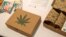 FILE - Cannabis product boxes are displayed at The Cannabis World Congress & Business Exposition (CWCBExpo) trade show in New York City, New York, May 30, 2019.