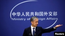 FILE - Chinese Foreign Ministry spokesman Wang Wenbin addresses reporters in Beijing, Dec. 14, 2020.