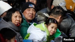 People watch the 14th Annual Chinatown Lunar New Year Parade, New York, Feb. 17, 2013.
