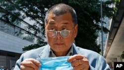 FILE - Hong Kong media tycoon Jimmy Lai enters a court in Hong Kong on May 5, 2020. A key prosecution witness in Lai's trial on collusion and sedition charges may have been mistreated in custody, U.N. officials say, drawing into question whether his testimony was coerced.