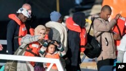 Migrants disembark at Hay Wharf, Pieta, Malta, Jan. 9, 2019. The 49 rescued migrants were brought to Malta, then distributed among eight EU countries. Italy and Malta have refused to let private rescue ships bring migrants to their shores. 