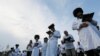 FILE - Orthodox Jewish pilgrims pray on a bank of a lake near the tomb of Rabbi Nachman of Breslov during the celebration of the Rosh Hashanah holiday, the Jewish New Year, in Uman, Ukraine, Sept. 21, 2017.