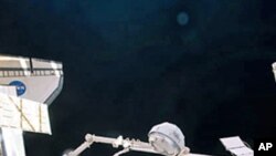 In the grasp of Canadarm2, the cupola is relocated from the forward port to the Earth-facing port of the International Space Station's newly-installed Tranquility node, 15 Feb 2010