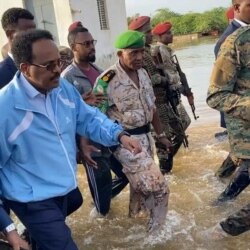 FILE - Somalia's President Mohamed Abdullahi Farmajo wades through flood waters in Beledweyn, Somalia November 2, 2019 in this still image obtained from social media video on Nov. 4, 2019.