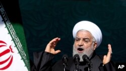 Iranian President Hassan Rouhani speaks during a ceremony celebrating the 41st anniversary of the Islamic Revolution, at Azadi (Freedom) Square in Tehran, Iran, Feb. 11, 2020.