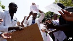 A group of Zimbabwean doctors sing as they protest at Parirenyatwa hospital in Harare, Zimbabwe, Sept. 15, 2019. 