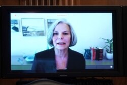FILE - Merck Executive Vice President and Chief Patient Officer Julie Gerberding is seen on a screen as she gives a statement during a Senate Health, Education, Labor and Pensions Committee hearing, June 23, 2020, on Capitol Hill in Washington.