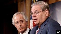 Senate Foreign Relations Committee Chairman Sen. Robert Menendez and the committee's ranking member, Sen. Bob Corker hold a news conference on Capitol Hill in Washington, March 27, 2014, after the Senate passed the Ukraine Aid Bill.