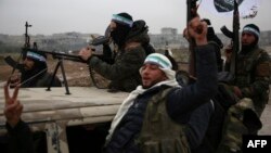 Turkish-backed Syrian fighters are pictured in the back of their trucks as they leave their barracks in the rebel-held border town of Jarabulus on Dec. 25, 2018, as they prepare to move towards Manbij.