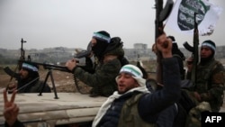 Turkish-backed Syrian fighters are pictured in the back of their trucks as they leave their barracks in the rebel-held border town of Jarabulus, Dec. 25, 2018, as they prepare to move toward Manbij.