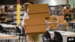 A worker sets up tables for hand counting Palm Beach County election ballots in West Palm Beach, Florida, Nov. 15, 2018.
