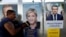 Campaign posters of French National Front (FN) political party leader Marine Le Pen (C) and head of the political movement En Marche! (Onwards!) Emmanuel Macron (R), are seen in Antibes, France, April 14, 2017.