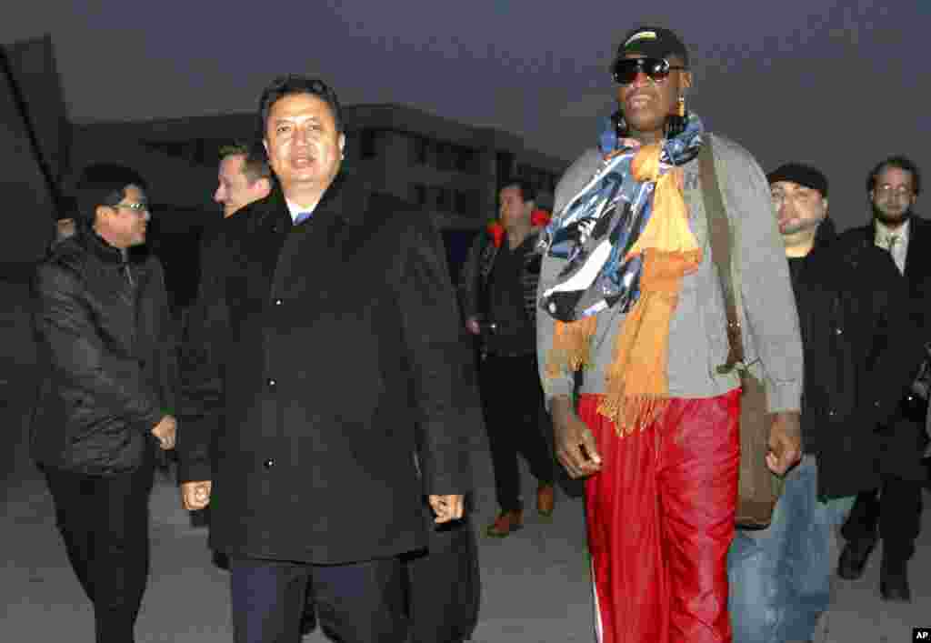 Dennis Rodman walks with Vice Minister of North Korea&#39;s Sports Ministry, Son Kwang Ho, as Rodman arrives at the international airport in Pyongyang, Dec. 19, 2013.