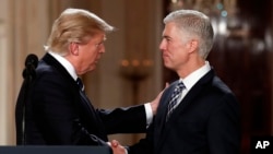 President Donald Trump shakes hands with 10th U.S. Circuit Court of Appeals Judge Neil Gorsuch, his choice for Supreme Court associate justice in the East Room of the White House in Washington, Tuesday, Jan. 31, 2017. 