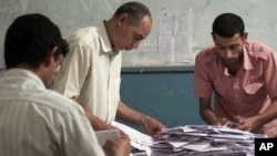Egyptian election workers count the ballots following the end of the two day presidential election at a school in Cairo, Egypt. Experts say the elections were fairly clean given Egypt's past corruption.