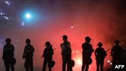 Police hold a perimeter near the White House as demonstrators gather to protest the killing of George Floyd in the morning hours on May 31, 2020, in Washington, DC.