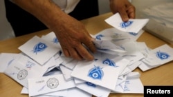 A Lebanese election official counts ballots after the polling station closed during Beirut's municipal elections in Lebanon, May 8, 2016.