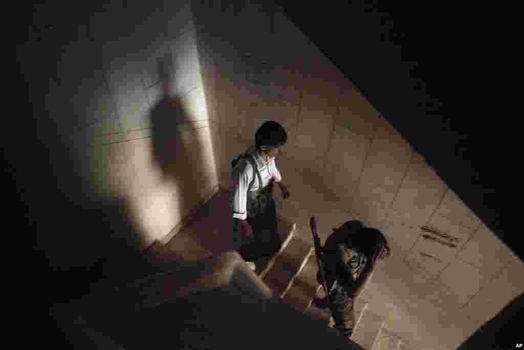 Free Syrian Army fighters walk down stairs in a damaged building in Aleppo, Syria, Sept. 26, 2012. 