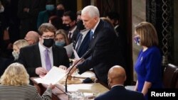 FILE - U.S. Vice President Mike Pence and Speaker of the House Nancy Pelosi take part in a joint session of Congress to certify the 2020 election results on Capitol Hill in Washington, Jan. 6, 2021. 