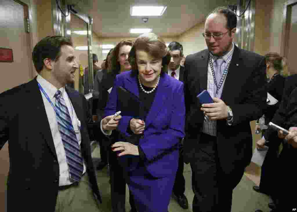 Senate Intelligence Committee Chair Sen. Dianne Feinstein, D-Calif. is pursued by reporters as she arrives to release a report on the CIA's harsh interrogation techniques at secret overseas facilities, Washington,&nbsp; Dec. 9, 2014.