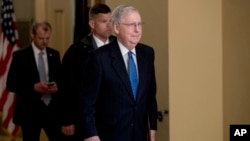 Senate Majority Leader Mitch McConnell of Ky. walks to the Senate Chamber on Capitol Hill in Washington, March 23, 2020, as the Senate is working to pass a coronavirus relief bill.
