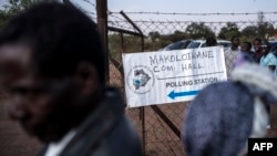 FILE - Residents queue to cast their ballots at a polling station in Serewe, Botswana, Oct. 24, 2014.