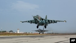 FILE - A Russian Su-25 jets takes off for a mission from Hemeimeem airbase in Syria, October 22, 2015.
