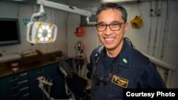 FILE - Vietnamese American Hien Trinh on the USS Carl Vinson.