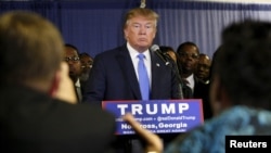 FILE - U.S. Republican presidential candidate Donald Trump, surrounded by members of Atlanta's black clergy, speaks at a news conference in Norcross, Georgia, Oct. 10, 2015.